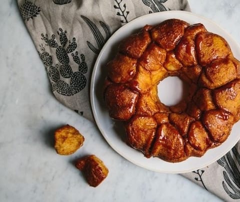 A golden ring cake on a white plate