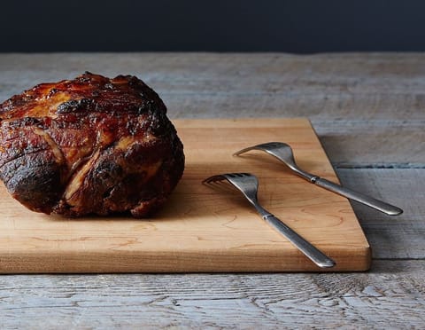 A smoked brisket on a wooden board